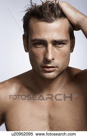 Mid adult man with hand in his hair View Large Photo Image Stock Photography - Mid adult man with hand in his hair. Fotosearch