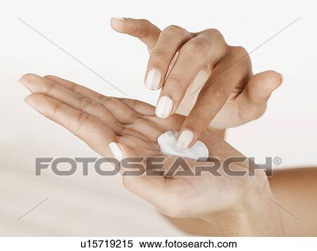 Stock Photography - Moisturizer on palm of hand (close-up). Fotosearch