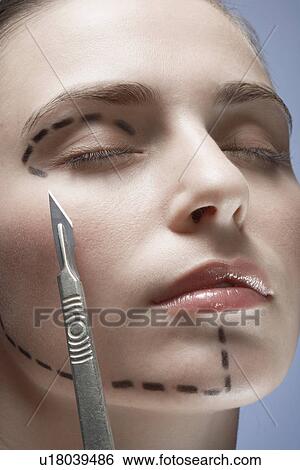 Scalpel near woman's face with dotted lines, close-up View Large Photo Image Stock Photograph - Scalpel near woman's face with dotted lines, close-up. Fotosearch
