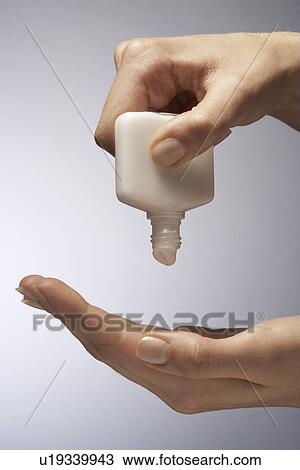 Woman squeezing moisturizer tub, close-up View Large Photo Image Stock Image - Woman squeezing moisturizer tub, close-up. Fotosearch