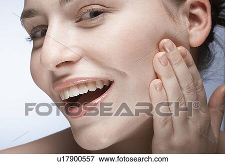 Woman with hand on face View Large Photo Image Stock Photo - Woman with hand on face. Fotosearch