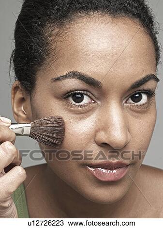 Young woman applying blush View Large Photo Image Stock Image - Young woman applying blush. Fotosearch