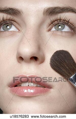 Young woman applying make-up with brush, close-up View Large Photo Image Stock Image - Young woman applying make-up with brush, close-up. Fotosearch