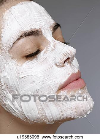 Young woman having face mask View Large Photo Image Stock Photo - Young woman having face mask. Fotosearch