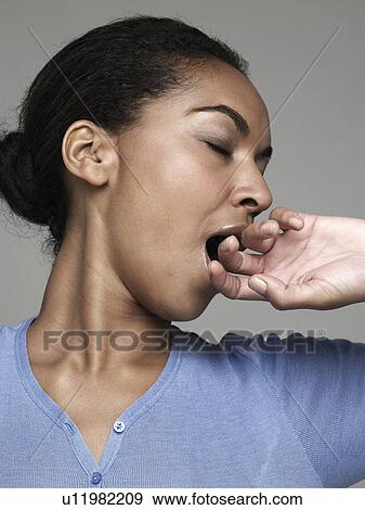 Stock Photo - Young woman yawning. Fotosearch