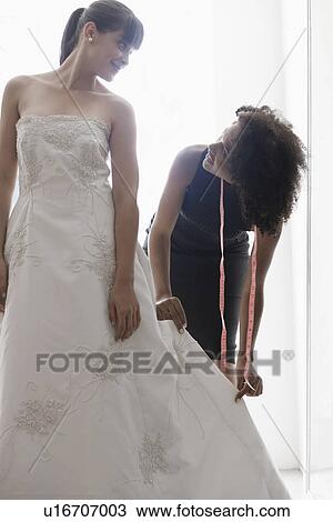 Woman Adjusting Bride S Wedding Dress Stock Image U16707003