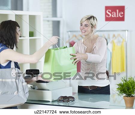 Young Woman Buying in Clothes Store View Large Photo Image Picture - Young Woman Buying in Clothes Store. Fotosearch
