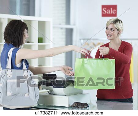 Young Woman Buying in Clothes Store View Large Photo Image Stock Image - Young Woman Buying in Clothes Store. Fotosearch