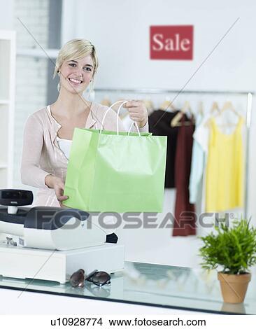 Young Woman With Shopping Bag in Clothes Store View Large Photo Image Picture - Young Woman With Shopping Bag in Clothes Store. Fotosearch