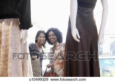 Young women window shopping dresses View Large Photo Image Stock Photo - Young women window shopping dresses. Fotosearch