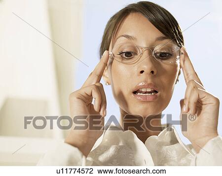Woman holding eyeglasses View Large Photo Image Stock Image - Woman holding eyeglasses. Fotosearch