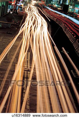 Stock Photo - Blurred Motion, Building Exterior, City Street, Illuminated. Fotosearch