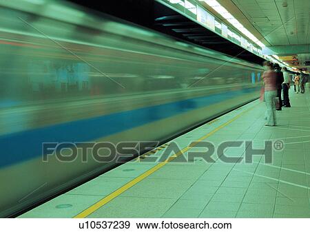 Stock Photo - Blurred Motion, Fast, Fluorescent Light, Group Of People. Fotosearch