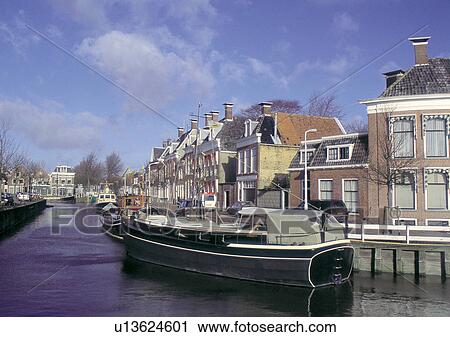 Stock Image - Blue Sky, Building Exterior, Clouds, Commercial Dock, Day. Fotosearch