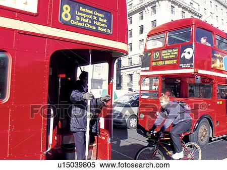 Stock Photography - Building Exterior, Car, City Street, Cycling, Day. Fotosearch