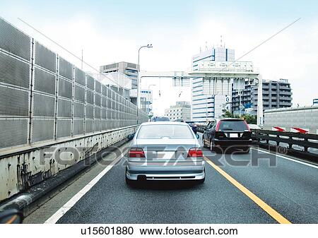 Stock Image - Buildings, Day, Clouds, Car, Arrow. Fotosearch