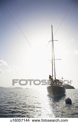 Couple on sailboat, St. John, US Virgin Islands, USA View Large Photo Image Picture - Couple on sailboat, St. John, US Virgin Islands, USA. Fotosearch