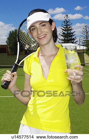 Female tennis player drinking icy water (portrait) View Large Photo Image Picture - Female tennis player drinking icy water (portrait). Fotosearch