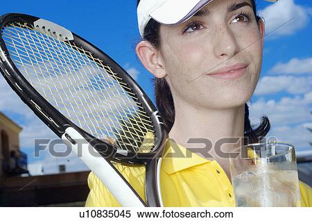 Female tennis player with glass of water (portrait) View Large Photo Image Stock Photography - Female tennis player with glass of water (portrait). Fotosearch