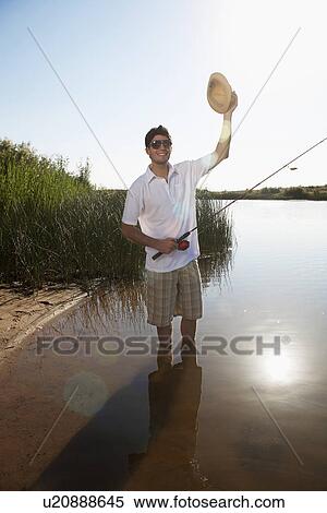 Fly-fisher greeting by lifting hat View Large Photo Image Stock Photography - Fly-fisher greeting by lifting hat. Fotosearch