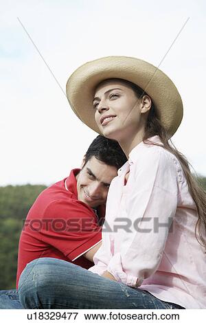 Young couple, woman wearing sun hat, portrait View Large Photo Image Stock Photo - Young couple, woman wearing sun hat, portrait. Fotosearch