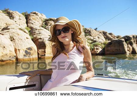 Young woman in motorboat View Large Photo Image Stock Image - Young woman in motorboat. Fotosearch