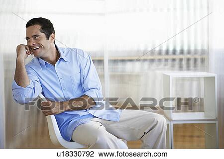 Stock Image - Mid adult office worker. Fotosearch