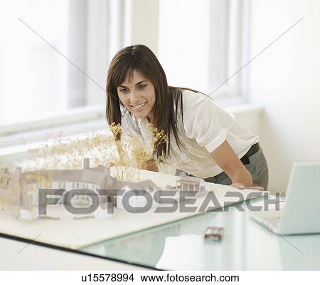 Picture - Mid-Adult Woman Looking at Architectural Model. Fotosearch