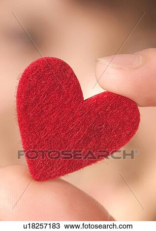 Stock Image - Love Tokens, Close-Up, Focus On Foreground, Heart Shape, Holding. Fotosearch