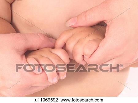 Stock Image - Baby Boys, Holding Hands, Close-Up, About Babies. Fotosearch