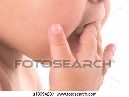 Stock Photo - Close-Up, Human Face, Finger In Mouth, About Babies. Fotosearch
