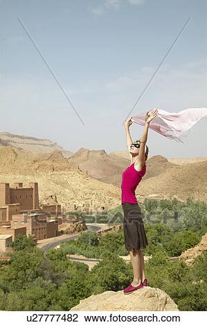 Woman Holding Up Scarf near Ruins View Large Photo Image Stock Image - Woman Holding Up Scarf near Ruins. Fotosearch