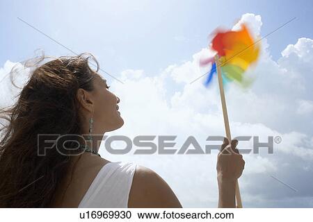 Young woman with pinwheel View Large Photo Image Stock Image - Young woman with pinwheel. Fotosearch