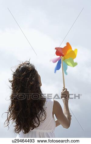 Stock Image - Young woman with pinwheel. Fotosearch