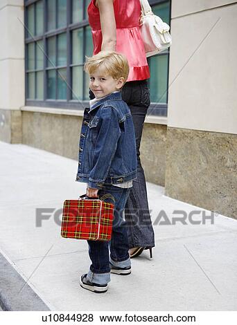 Mother taking son to school View Large Photo Image Stock Photo - Mother taking son to school. Fotosearch