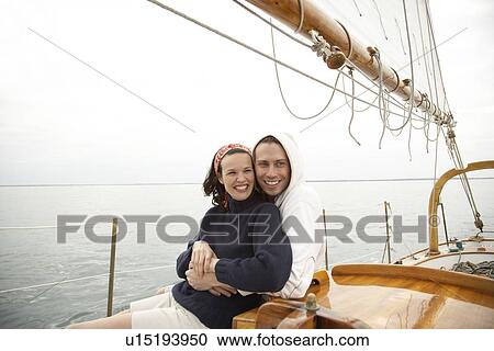 Young couple hugging in sailing boat View Large Photo Image Stock Image - Young couple hugging in sailing boat. Fotosearch