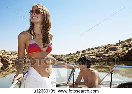 Stock Photography - Young couple in motorboat. Fotosearch