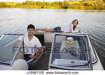 Young couple sailing with motorboat View Large Photo Image Stock Image - Young couple sailing with motorboat. Fotosearch