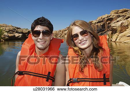 Young woman wearing life jackets View Large Photo Image Stock Photograph - Young woman wearing life jackets. Fotosearch