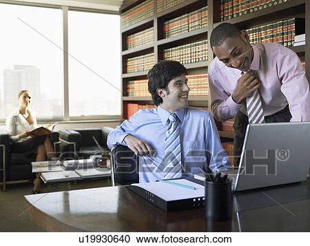 Businessmen using laptop computer in library View Large Photo Image Stock Image - Businessmen using laptop computer in library. Fotosearch