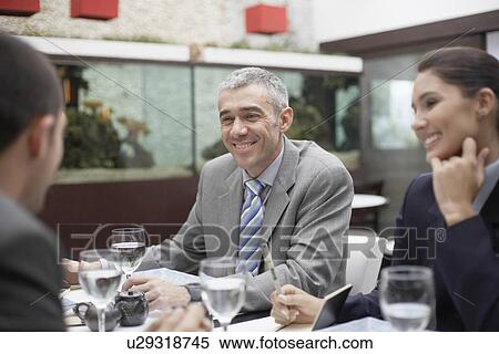 Stock Photography - Businesspeople having lunch. Fotosearch