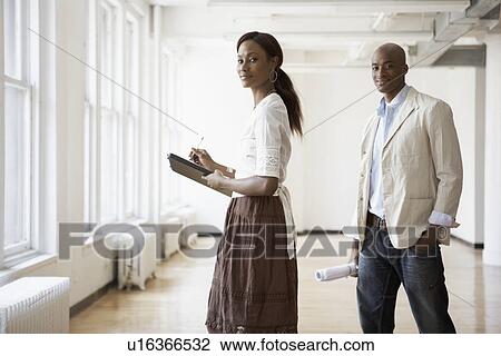 Businesspeople in bare room View Large Photo Image Stock Image - Businesspeople in bare room. Fotosearch