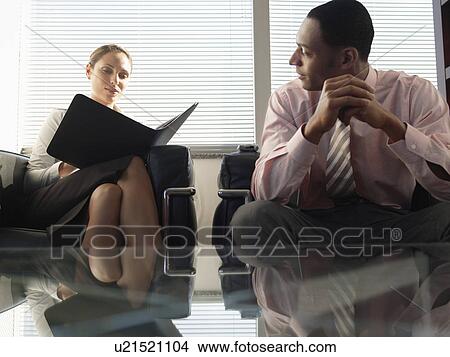 Businesspeople sitting on armchairs and talking View Large Photo Image Picture - Businesspeople sitting on armchairs and talking. Fotosearch