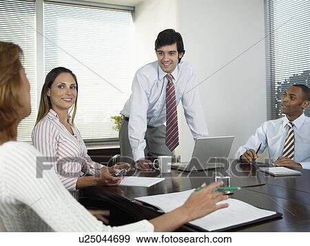 Stock Photo - Four businesspeople in meeting. Fotosearch