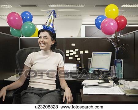 Office worker wearing party hat View Large Photo Image Stock Photo - Office worker wearing party hat. Fotosearch
