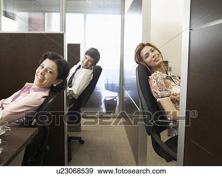 Stock Photo - Office workers at desks (portrait). Fotosearch