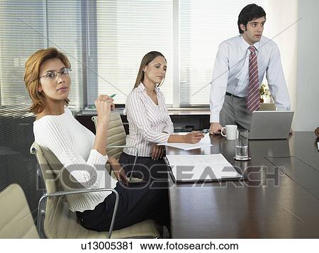 Three businesspeople in meeting View Large Photo Image Stock Image - Three businesspeople in meeting. Fotosearch