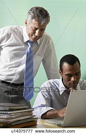 Stock Photo - Two Businessmen Working. Fotosearch