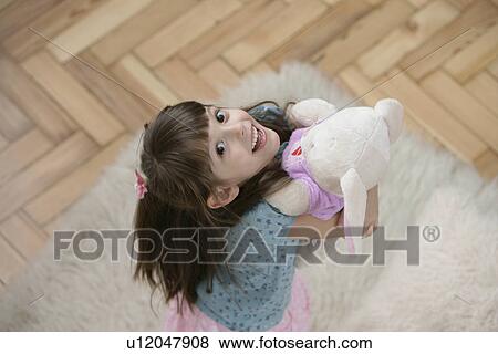 Girl with teddy bear (high angle view) View Large Photo Image Stock Photo - Girl with teddy bear (high angle view). Fotosearch