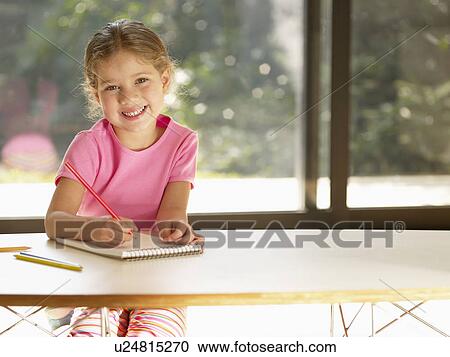 Girl writing with colored pencil on notepad (portrait) View Large Photo Image Stock Image - Girl writing with colored pencil on notepad (portrait). Fotosearch